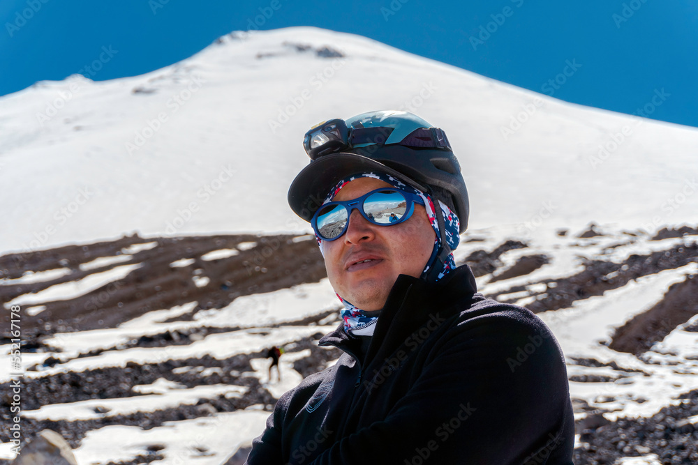 Photo of a male traveler in the winter in the mountains close-up.
