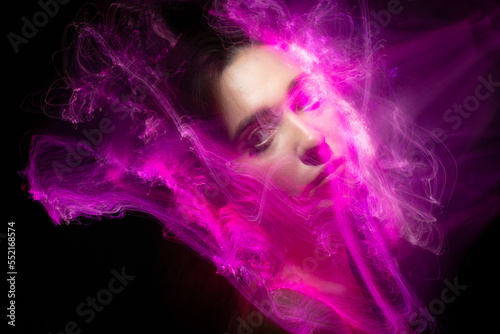 Abstract photography in the style of light painting. girl on a black background