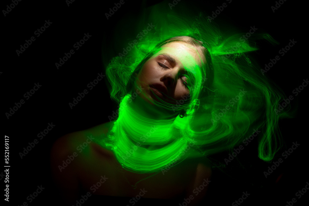 Abstract photography in the style of light painting. girl on a black background