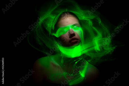 Fototapeta Naklejka Na Ścianę i Meble -  Abstract photography in the style of light painting. girl on a black background