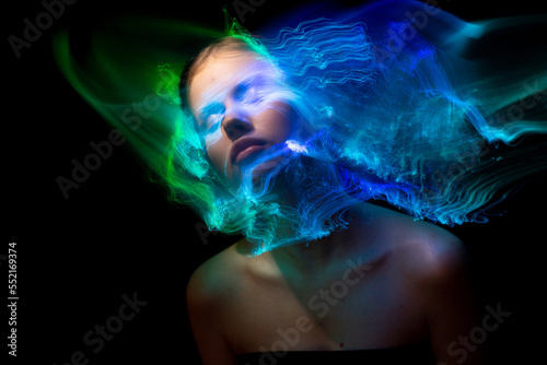 Abstract photography in the style of light painting. girl on a black background