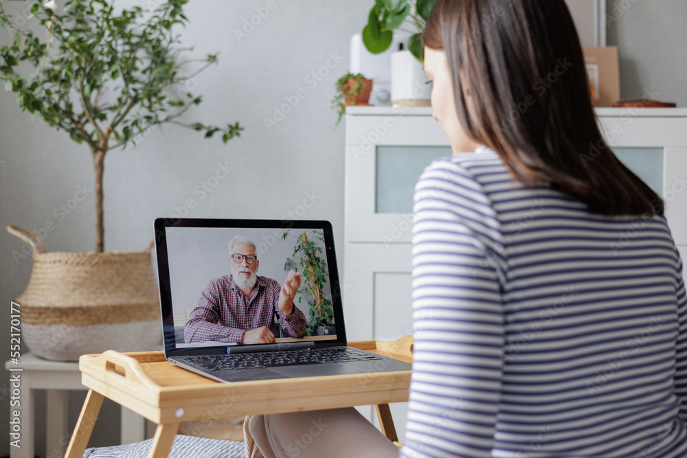 video chat woman communicates with man via video communication from laptop and makes notes, training webinar, friendly communication. online consultation, home office, modern technologies