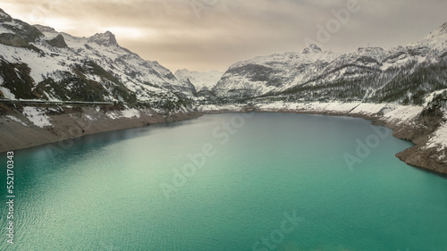 frozen lake in the middle of the alps, Mountains of pine trees covered with snow and beautiful lake in winter