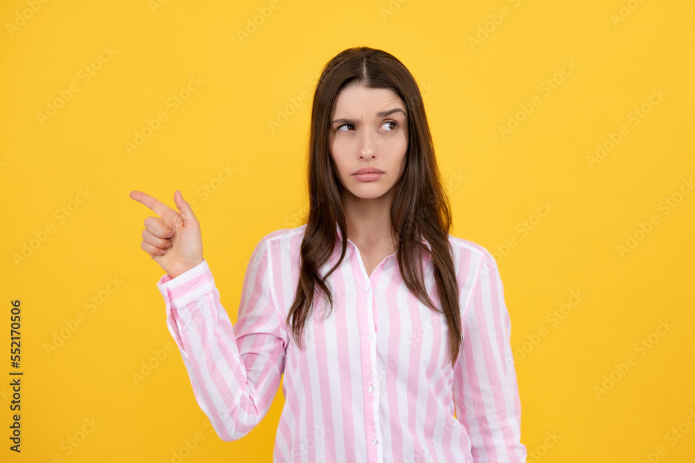 Woman point at copy space, showing copyspace pointing. Promo, girl showing advertisement content gesture, pointing with hand recommend product. Isolated yellow background. Woman point at copy space, showing copyspace pointing. Promo, girl showing advertisement content gesture, pointing with hand recommend product. Isolated yellow background.