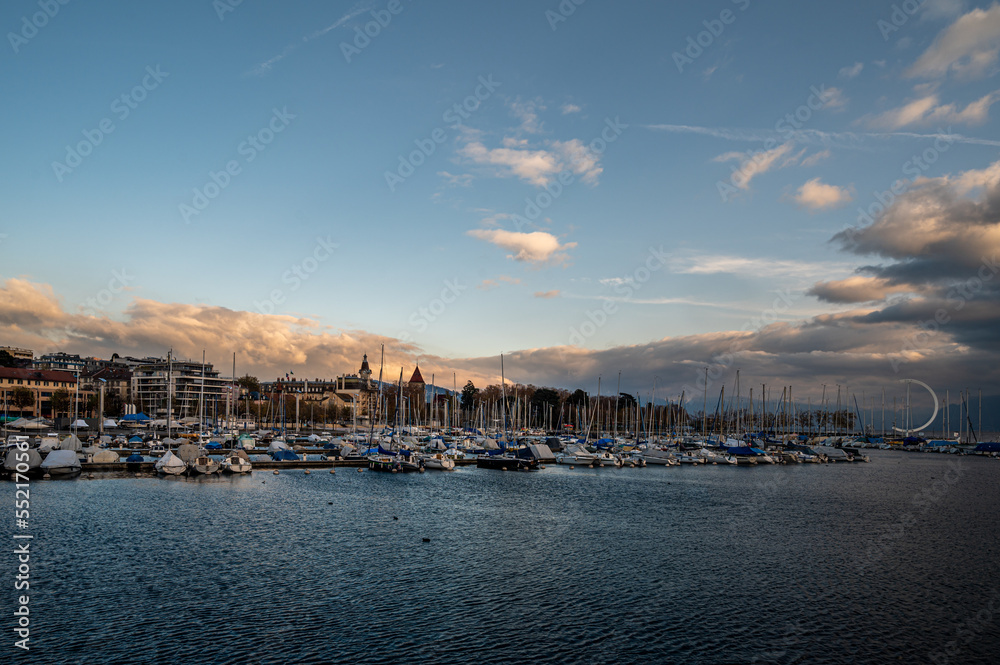 Landscape of boats, architecture and clouds. Port of Ouchy. Lake Geneva, Lausanne, Switzerland.