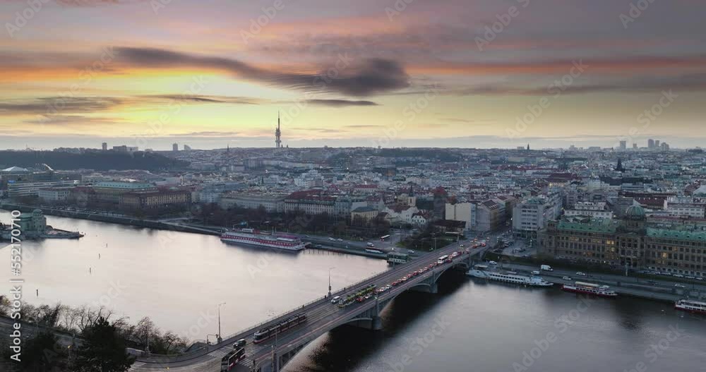 Early sunrise Prague Štefánik Bridge traffic bordering old town and new town with traffic at Vltava, city river and bridge traffic ship on the water skyline Early sunrise Prague Štefánik Bridge traffic bordering old town and new town with traffic at Vltava, city river and bridge traffic ship on the water skyline