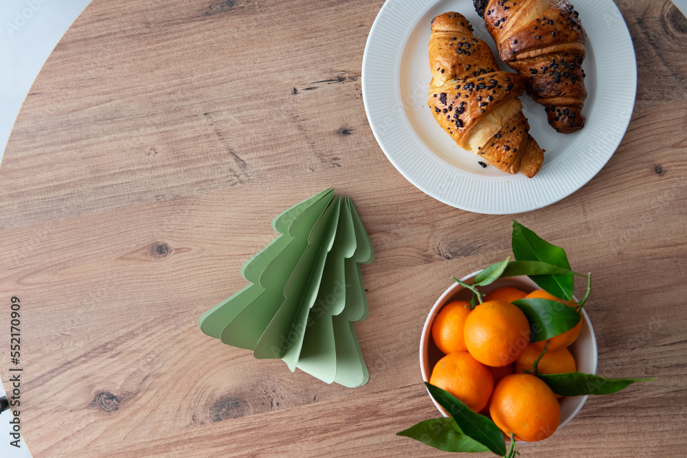 christmas breakfast with croissants and tangerines. christmas breakfast with croissants and tangerines.