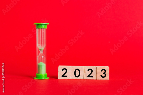 New Year 2023 sand timer. Resolution, time, plan, goal, motivation, reboot, countdown and New Year holiday concepts. Hourglass with number 2023
