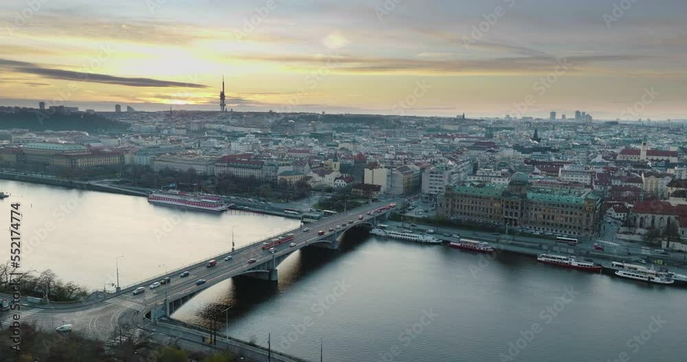 Sunrise at Prague Štefánik Bridge traffic bordering old town and new town with traffic at Vltava, city river and bridge traffic ship on the water skyline Sunrise at Prague Štefánik Bridge traffic bordering old town and new town with traffic at Vltava, city river and bridge traffic ship on the water skyline