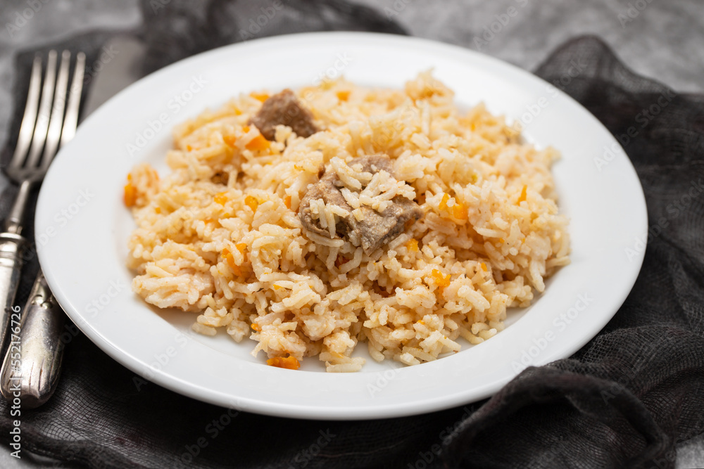 Rice with vegetables and meat on white plate Rice with vegetables and meat on white plate