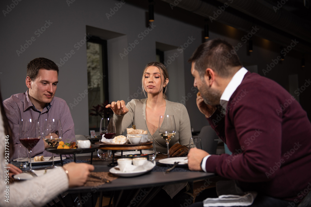 Group of Happy friends having lunch in the restaurant. Sharing food Group of Happy friends having lunch in the restaurant. Sharing food