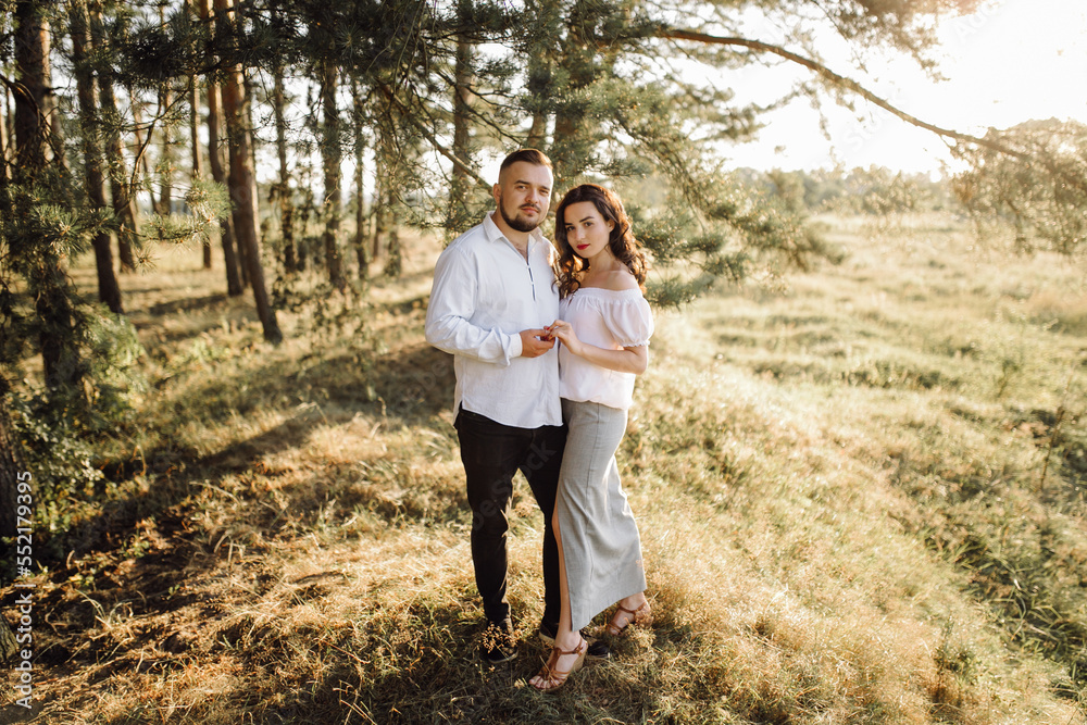 Fototapeta premium Young couple in love walking in the park