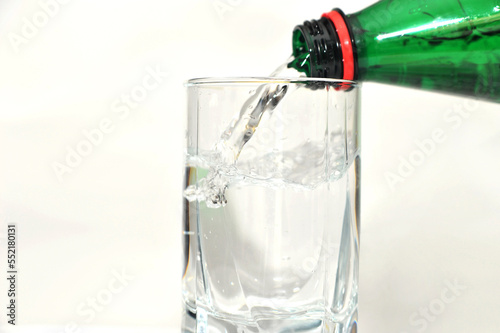 Pouring bottled mineral water into the glass