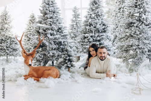 portrait of a young couple in their living room near christmas tree