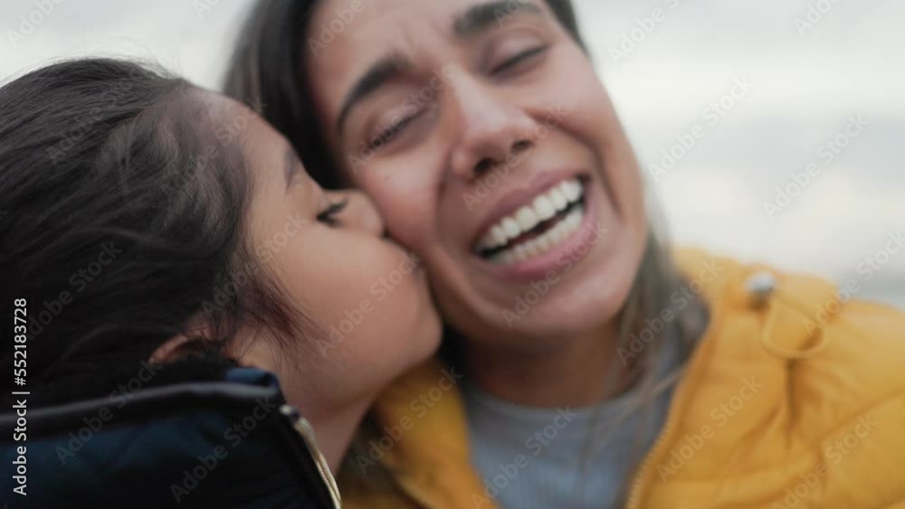 Happy latin mother and daughter having fun with outdoor in winter day - Family and love concept Happy latin mother and daughter having fun with outdoor in winter day - Family and love concept