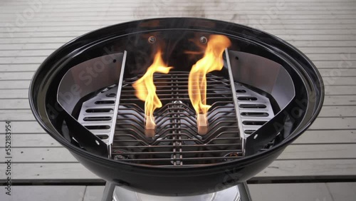 Lighting Fire starter igniting fuel in a Kettle Charcoal BBQ