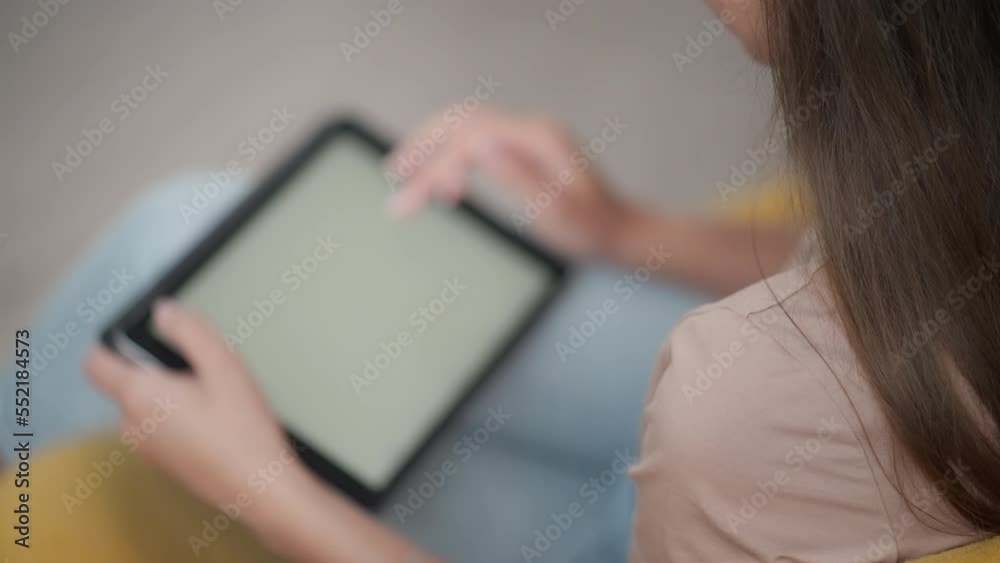 Girl browsing web and looking through photos on digital tablet Girl browsing web and looking through photos on digital tablet