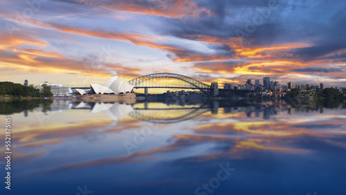 Sydney Harbour Australia at Sunset with the reflection of the Buildings and high rise offices of the City in the water