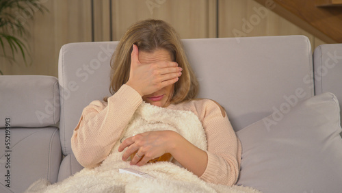 CLOSE UP: Young lady getting scared while watching thriller movie on television