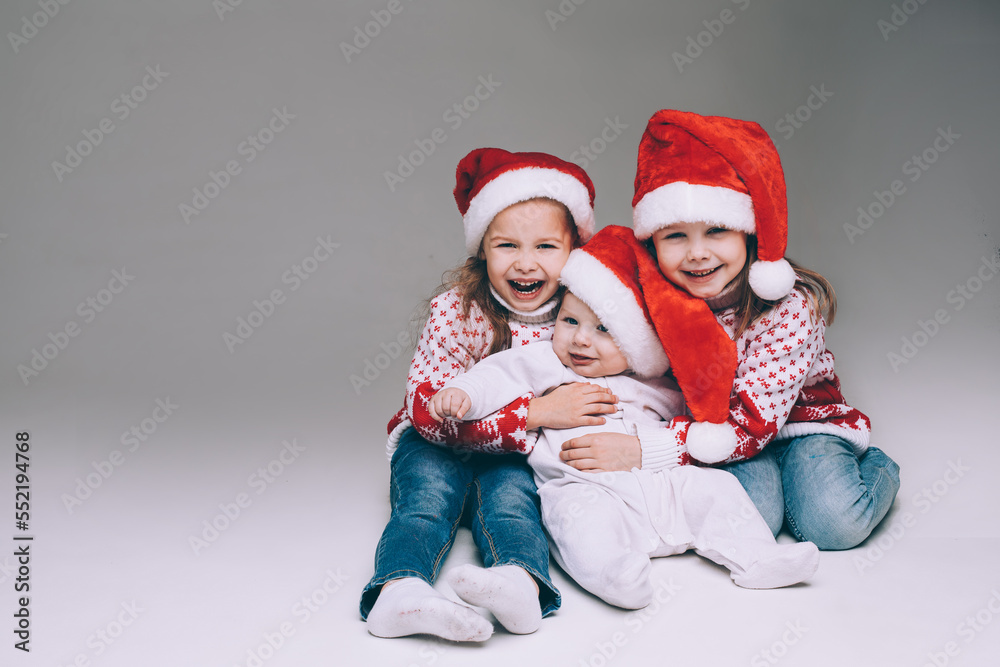 Laughing sisters with baby brother at xmas. Laughing sisters with baby brother at xmas.