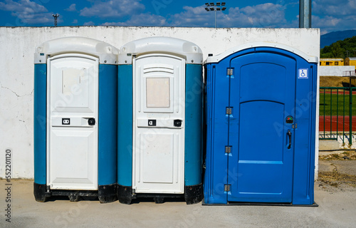 Public toilets. Blue Mobile toilets. Plastic portable chemical toilets. 