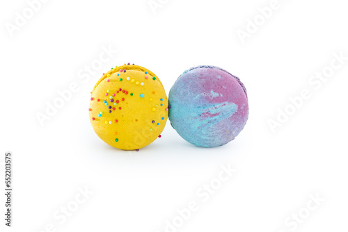 Sweet colorful macarons isolated on white background. Tasty colourful macaroons. Two multi-colored blue and yellow macaroons. French pastry made from egg whites.