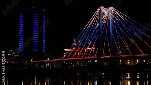 Tricolor bridge in the city at night