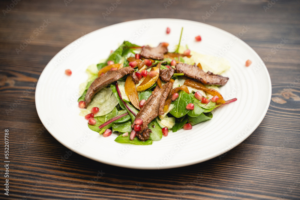 tasty and fresh meat salad on a plate in a restaurant from a chef. tasty and fresh meat salad on a plate in a restaurant from a chef.
