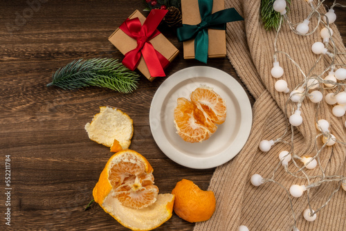 christmas concept with Tangerines  presents  Fir  scarf  lights  on wooden background