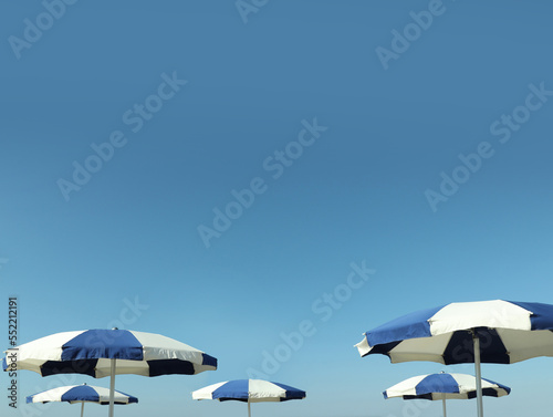 Beach umbrellas against blue sky on sunny day