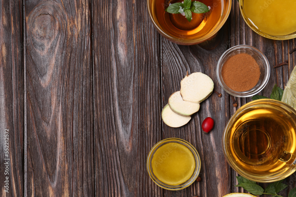 Flat lay composition of tea with honey and ingredients on wooden table. Space for text Flat lay composition of tea with honey and ingredients on wooden table. Space for text