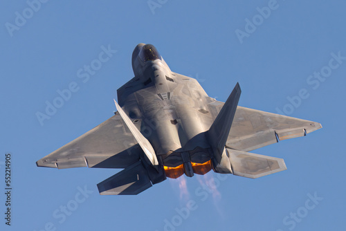 Close view of a F-22 Raptor in beautiful light ,  with afterburners on