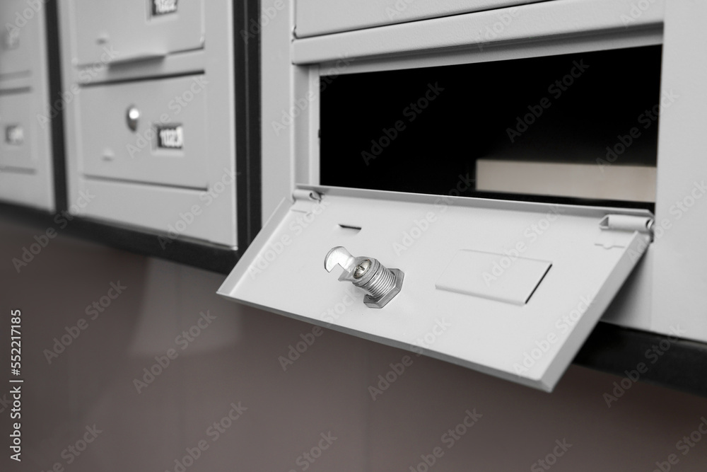 Open empty metal mailbox with keyhole indoors Open empty metal mailbox with keyhole indoors