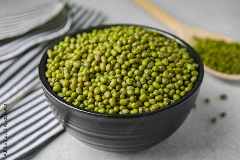 Bowl with green mung beans on grey table, closeup Bowl with green mung beans on grey table, closeup