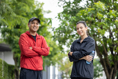 Couple jogging and running outdoors in nature. Happy Man woman wearing sportswear jogging in the Nature. Male and female in running uniform at outdoor. Workout exercise. Healthy and lifestyle.