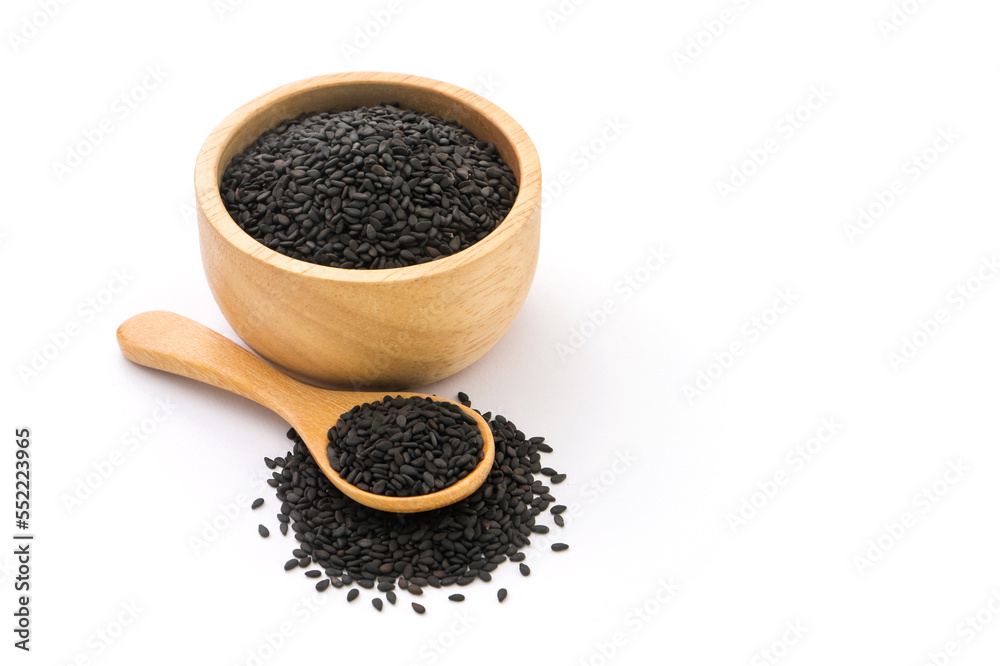 Black sesame seeds in wooden bowl and spoon isolated on white background. Black sesame seeds in wooden bowl and spoon isolated on white background.