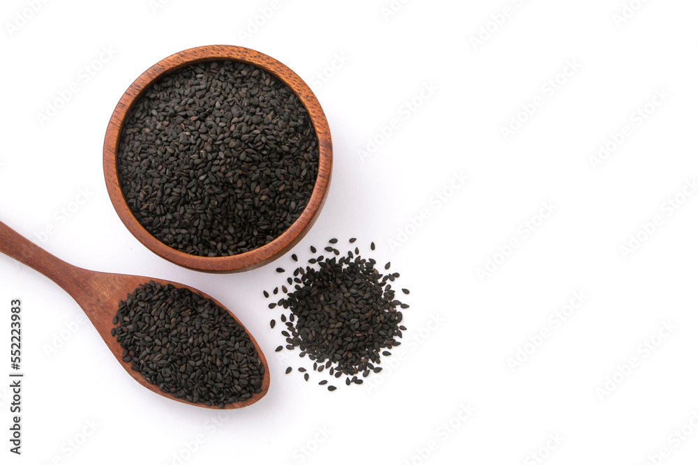 Black sesame seeds in wooden bowl and spoon isolated on white background , top view , flat lay. Black sesame seeds in wooden bowl and spoon isolated on white background , top view , flat lay.