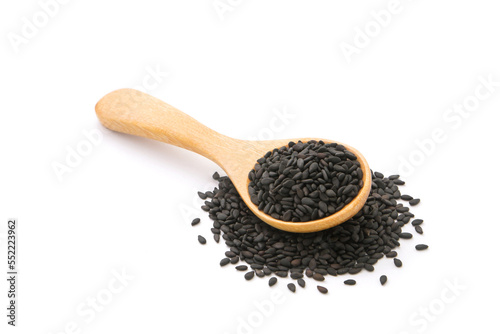 Black sesame seeds in wooden spoon isolated on white background.
