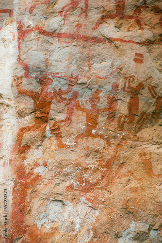 Close up view of 16,000 year old Aboriginal rock paintings of hunters at Zuojiang Huashan rock art site in Guangxi, China photo