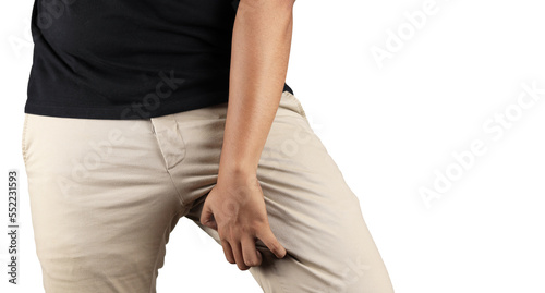 Obraz na plátně Asian man in reaction of scratching crotch on grey background, closeup