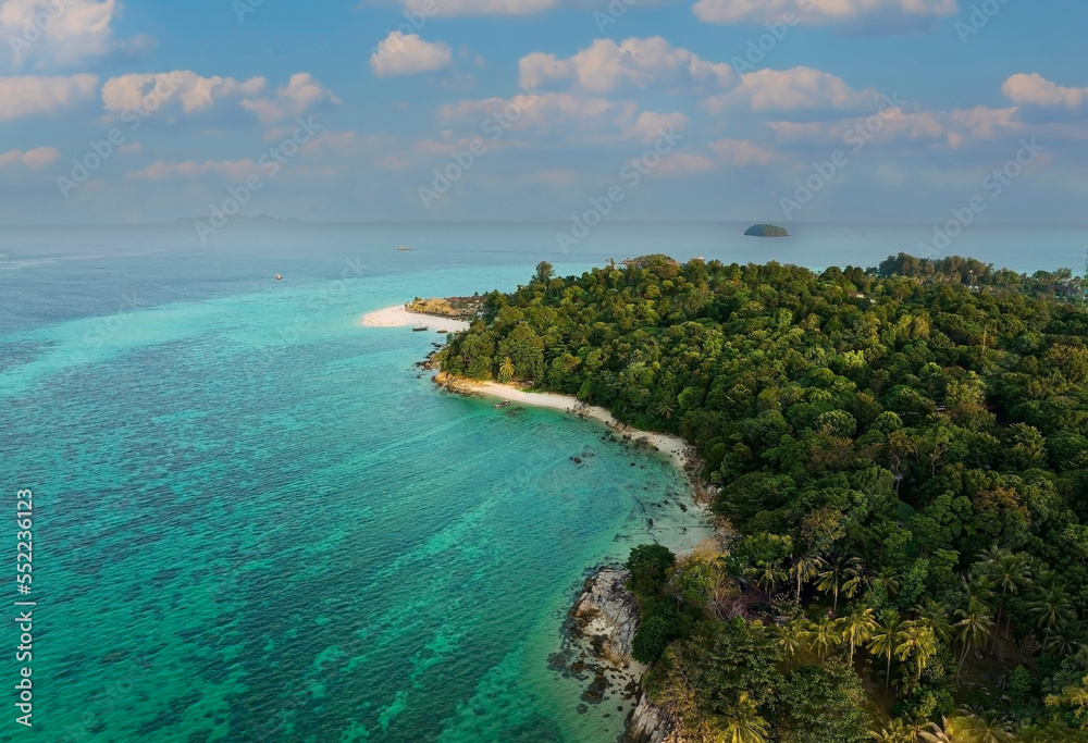 Aerial view of  tropical with seashore as the island in a coral reef ,blue and turquoise sea Amazing nature landscape with blue lagoon