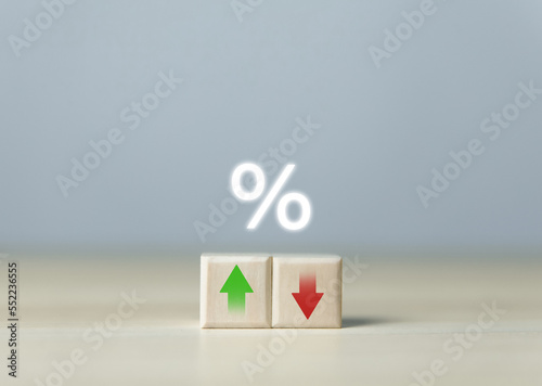 Wooden cube blocks with percentage icons and up or down arrows. Bank interest rates, stocks, dividends