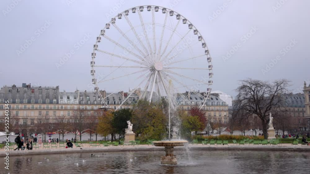 View on Park with Ferris wheel near Louvre Museum square. Places of interest in Paris, France. Beautiful French architecture. Threes, people. Tourism, famous destinations. High quality 4k footage View on Park with Ferris wheel near Louvre Museum square. Places of interest in Paris, France. Beautiful French architecture. Threes, people. Tourism, famous destinations. High quality 4k footage