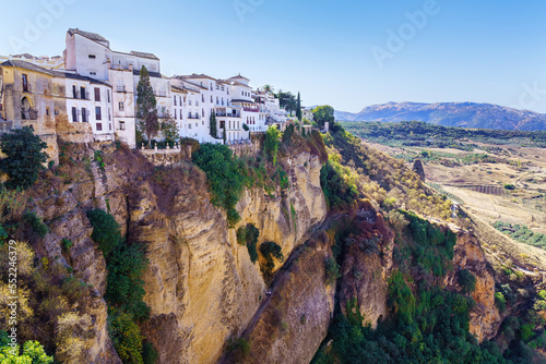 Stunning mountainous landscape with houses hanging on the precipice in Ronda, Malaga Spain.