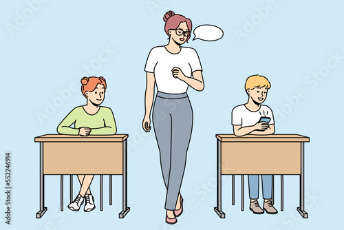 Teacher makes remark to schoolboy looking at cell phone in classroom. Teacher gives comment to pupil playing in smartphone at lesson at school. Vector outline colorful illustration isolated on blue.