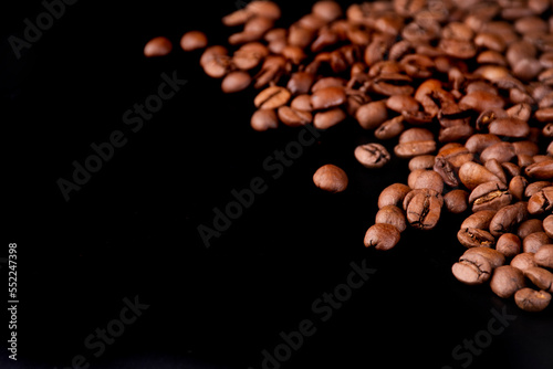 background for letter of specialty coffees from portion cafeteria in organic coffee beans in the right corner with black background direct from the Brazilian producer type arabica spilled 