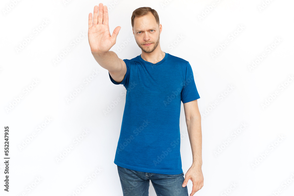 Caucasian man showing stop gesture at camera. Serious man pulling palm toward camera, warning, protecting from making bad choice, showing rejection sign. Protection, safety, defense, control concept Caucasian man showing stop gesture at camera. Serious man pulling palm toward camera, warning, protecting from making bad choice, showing rejection sign. Protection, safety, defense, control concept