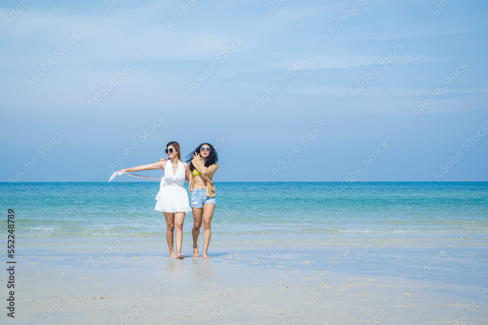 Young women with friends enjoying on the beach,Happiness woman on beach.