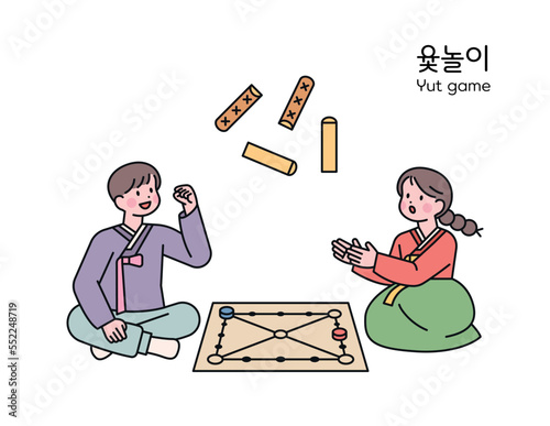 korean traditional play. Two friends wearing hanbok are playing Yutnori, a traditional board game.