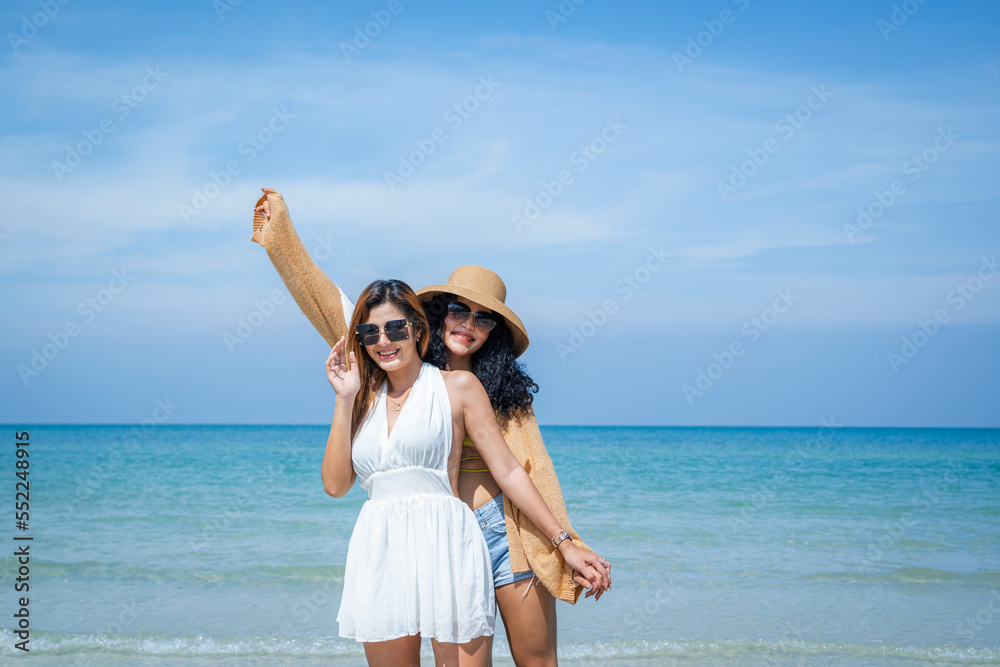 Two women in summer casual clothes play in the sea on vacation,Concept vacation,Holiday in summer. Two women in summer casual clothes play in the sea on vacation,Concept vacation,Holiday in summer.